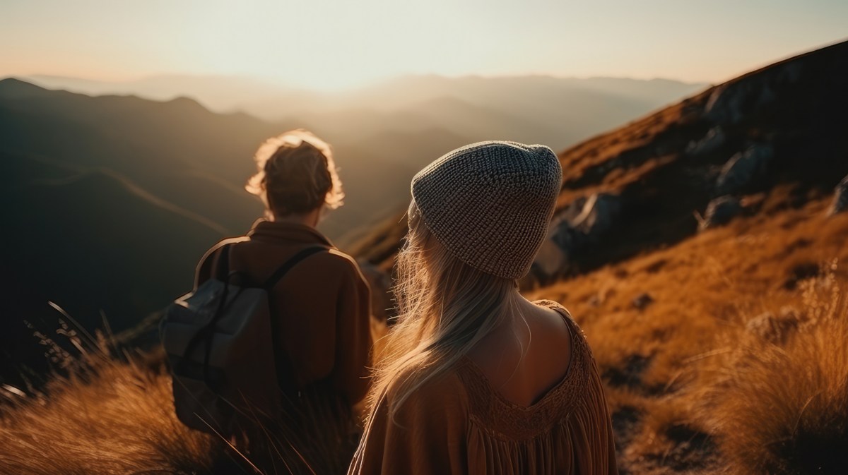 Mann und Frau auf Hügel im Sonnenuntergang