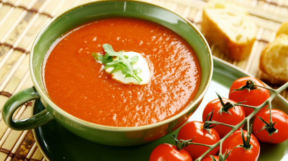 Tomatensuppe in einer grünen Suppenschüssel.