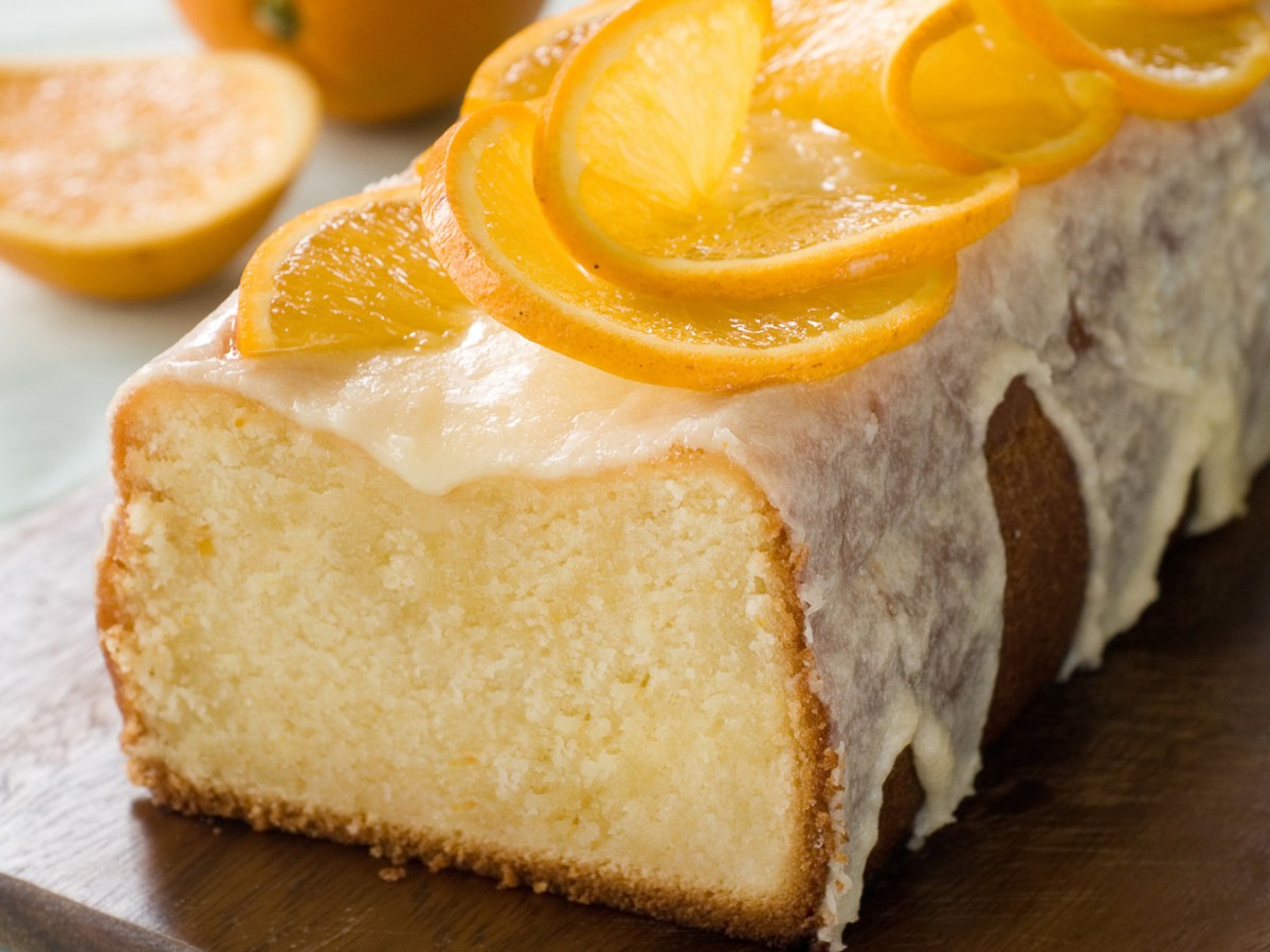 Kastenkuchen mit Orangenglasur und Orangenscheiben.