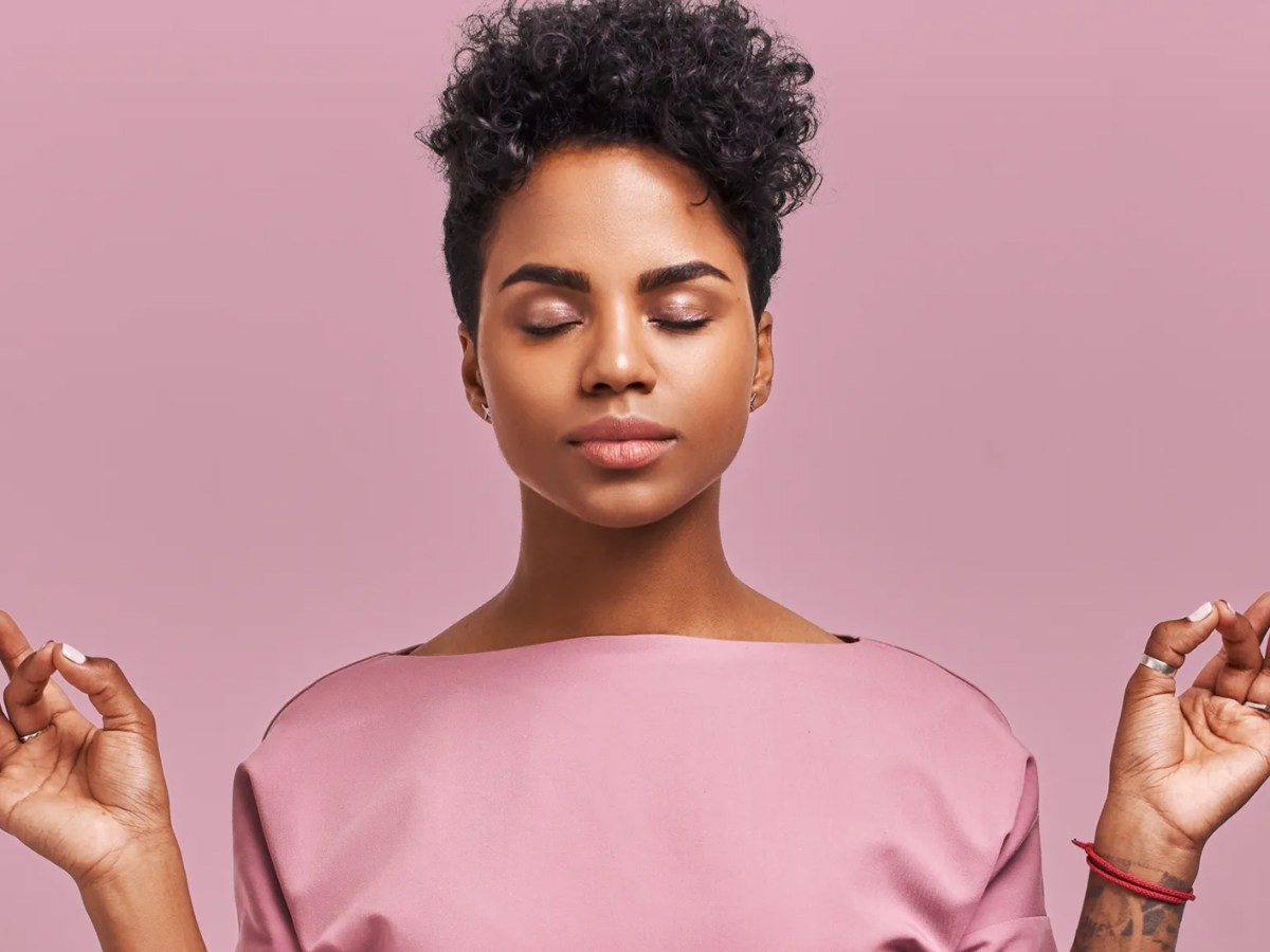 Frau, die meditiert und die Augen geschlossen hält.