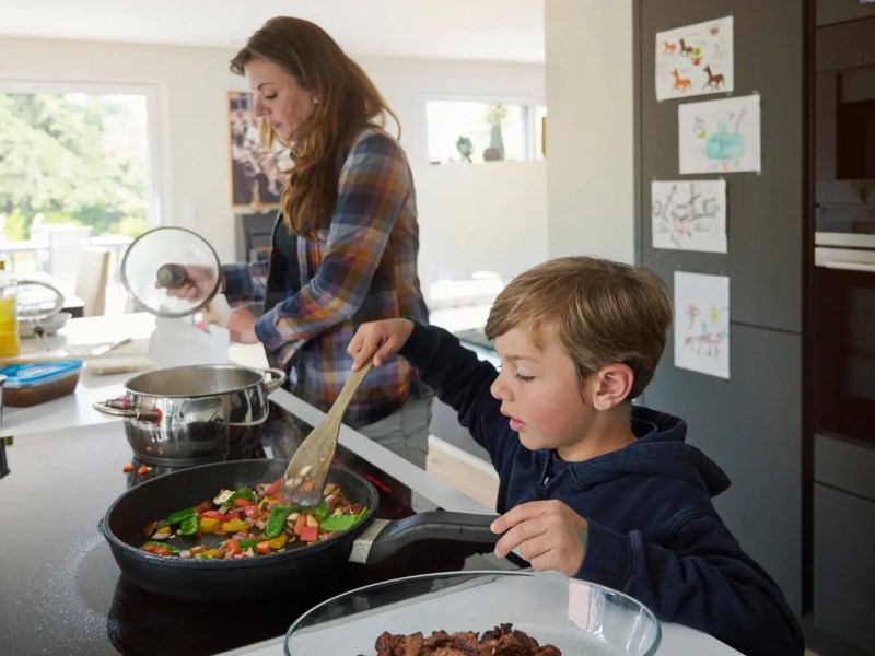 Mutter und Sohn kochen gemeinsam in der Küche.