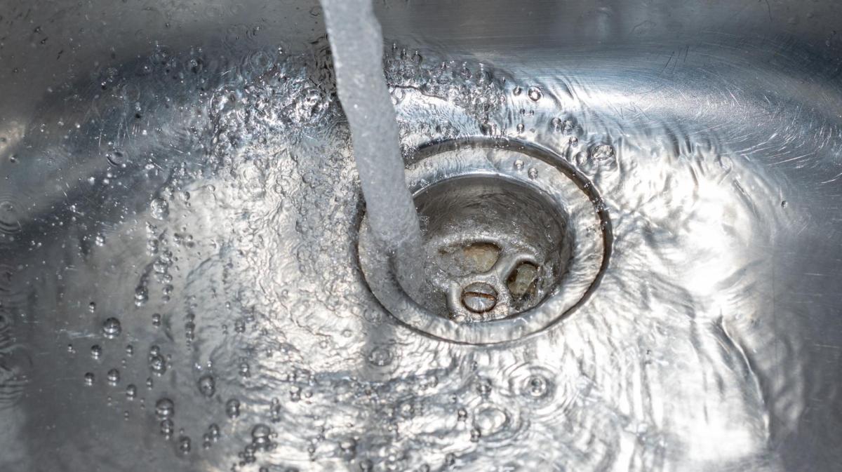 Wasser fließt in den Abfluss im Spülbecken in der Küche.