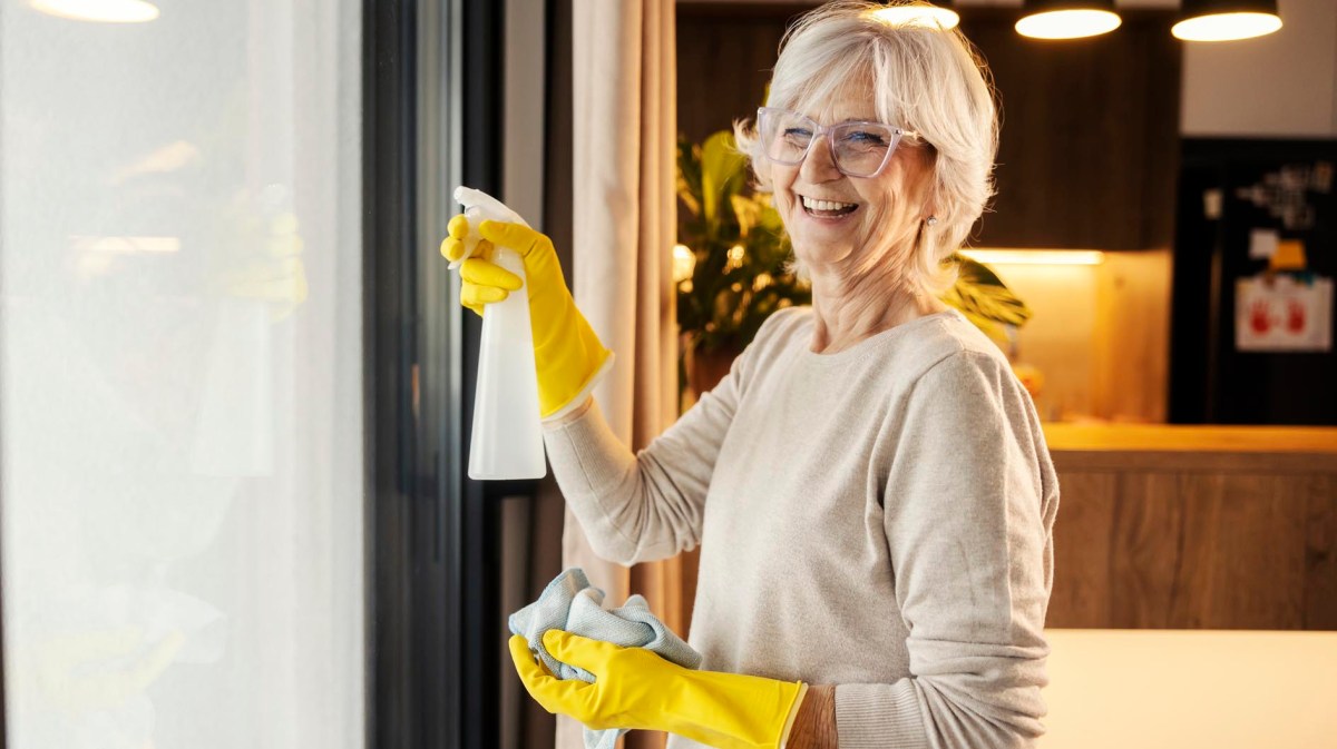 Reife Frau putzt Fenster