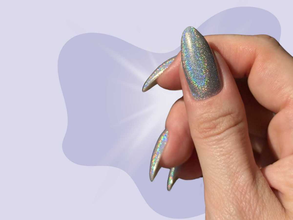 Holografische N&auml;gel in einem grauen Farbton vor einem lilafarbenen Hintergrund