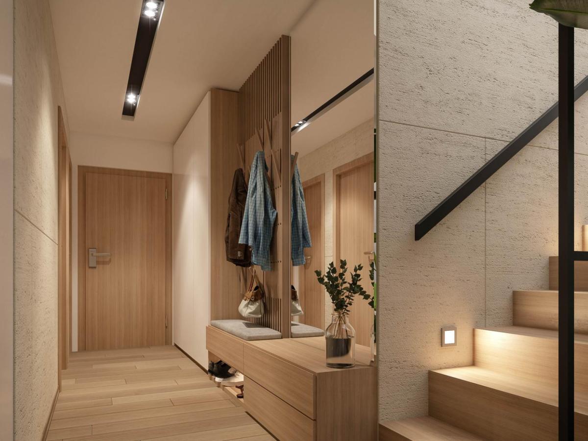 Luxuriöser Hausflur mit einer Garderobe und einem Schrank und einer Treppe in Beigetönen.