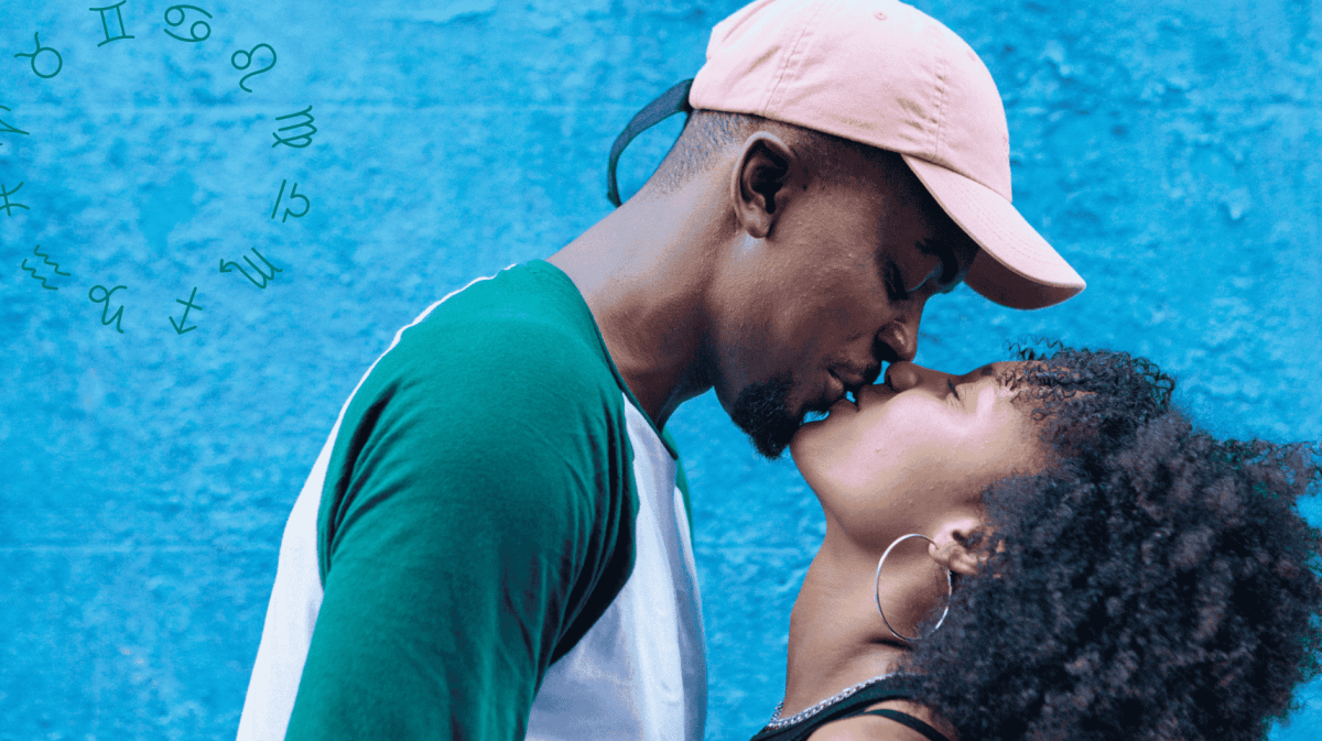 Frau und Mann küssen sich vor blauer Wand