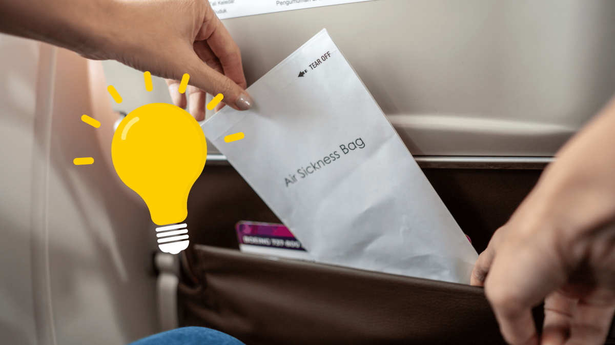 Person zieht Spuckbeutel aus Vordersitz im Flugzeug.