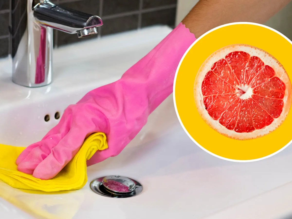 Hand in pinkem Putzhandschuh putzt Waschbecken mit gelbem Tuch, daneben Kreis mit Grapefruit