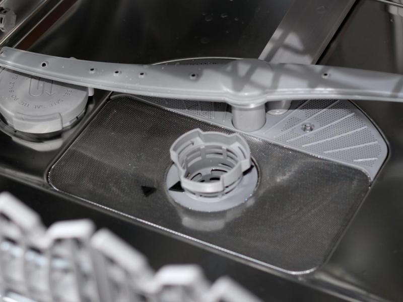 Innenraum einer Spülmaschine. Zu sehen ist der untere Sprüharm und der Filter.