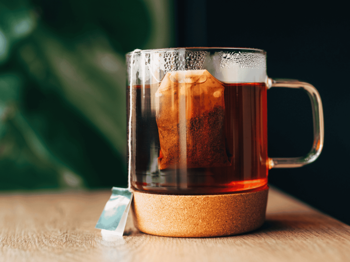 Teetasse aus Glas mit Teebeutel drin.