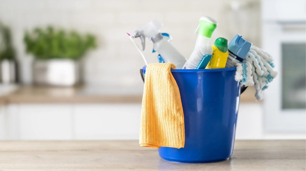 Blauer Putzeimer mit verschiedenem Putzmittel.