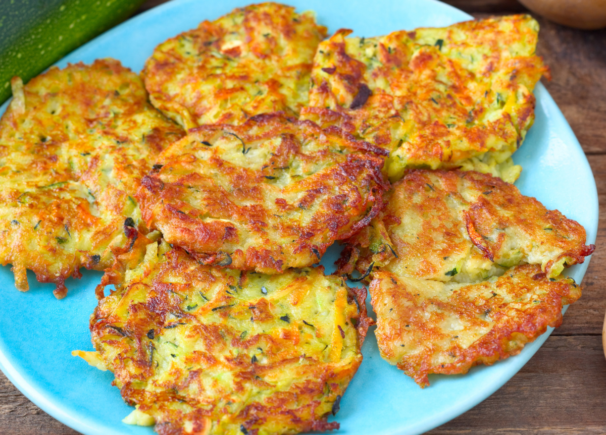 Rösti aus Kartoffeln und Zucchini auf einem blauen Teller.